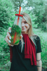 Midsection of woman drinking glass