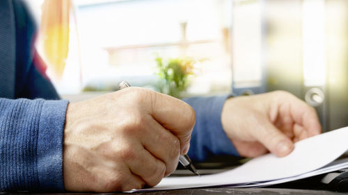 Close-up of man hand on table