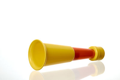 Close-up of yellow colored pencils against white background