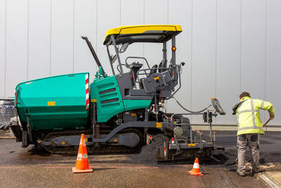 Rear view of worker working at construction site