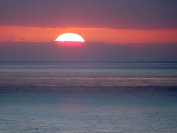 Scenic view of sea against romantic sky at sunset