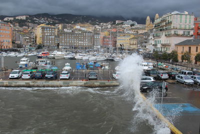 View of city by sea against sky