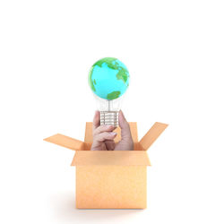 Close-up of person holding toy against white background