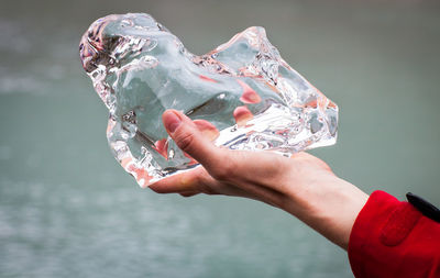 Cropped image of hand holding ice