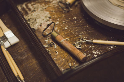 Close-up of tools on table in pottery workshop