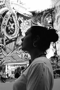 Portrait of young woman looking away outdoors