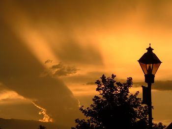 Low angle view of silhouette trees against sky during sunset