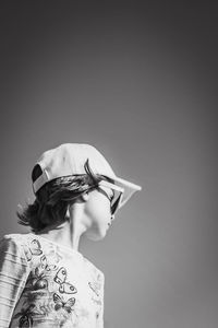 Rear view of young woman against white background