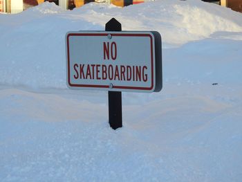 Information sign on snow covered field