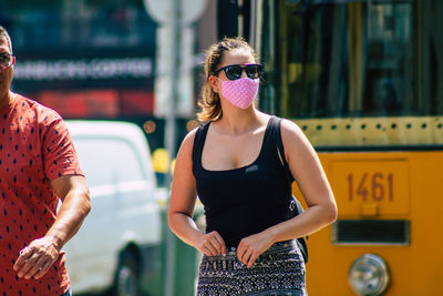 Young woman wearing sunglasses standing outdoors