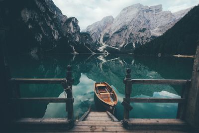 Empty wooden boat on lake with water reflection