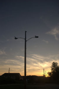 Low angle view of windmill against cloudy sky