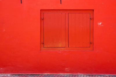 Close-up of closed door of red wall
