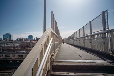 Railroad tracks in city against sky