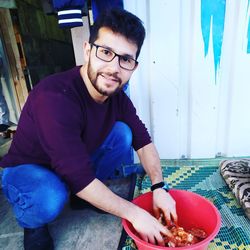 Portrait of young man preparing food in container