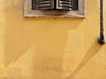 Low angle view of yellow wall of building