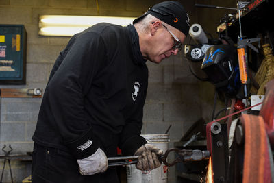 Side view of man working in factory