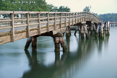 Wooden pier on lake against sky