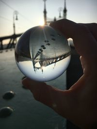 Close-up of hand holding crystal ball