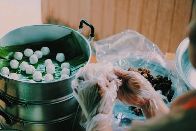 High angle view of people in container on table