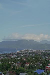 High angle view of townscape and mountains against sky