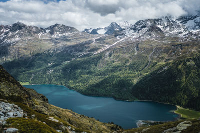 Snow covered mountains above silvaplana lake, engadin, switzerland