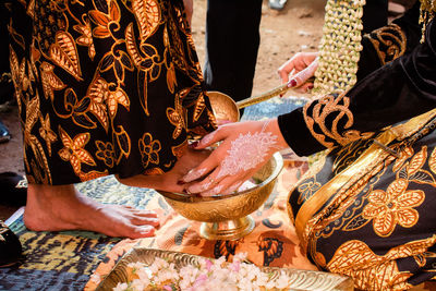 Midsection of people sitting in temple