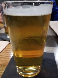 Close-up of beer glass on table