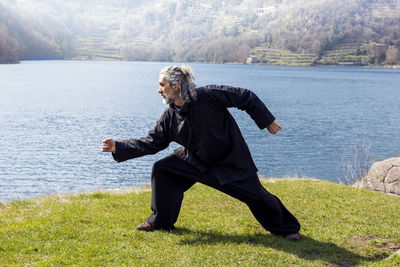 Man exercising by lake