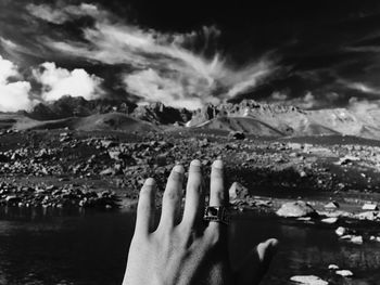 Scenic view of hand against sky