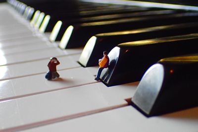 High angle view of toys on piano keys