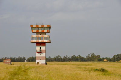 Built structure on field against sky