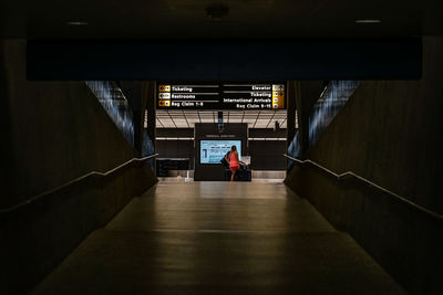 Rear view of people walking in subway