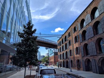 Cars on street with buildings in background