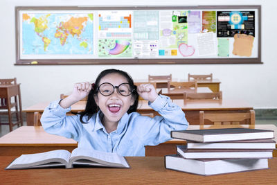 Portrait of happy girl sitting in classroom