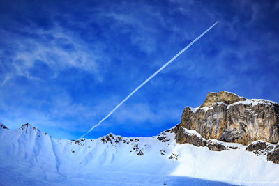 Low angle view of vapor trail against blue sky