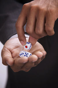 Midsection of businessman holding dice