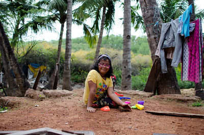 Portrait of smiling young woman sitting outdoors