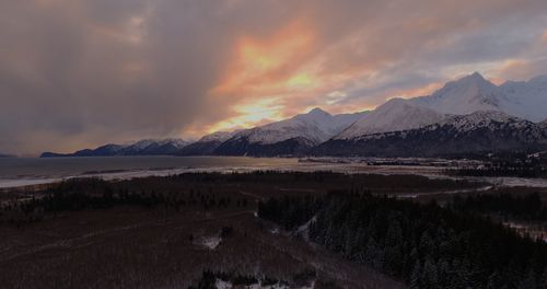 Scenic view of snowcapped mountains against sky during sunset