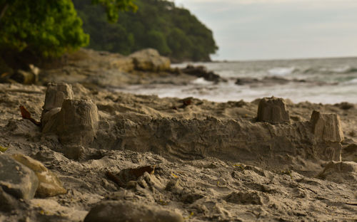 Sandcastle at beach against sky