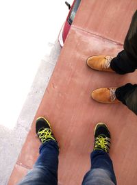 Low section of man standing on tiled floor