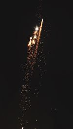 Low angle view of firework display at night