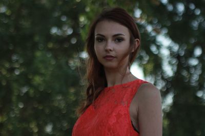 Portrait of beautiful young woman standing in park