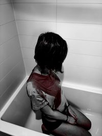 High angle view of woman sitting on floor at home