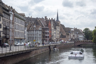 Boats in river with buildings in background