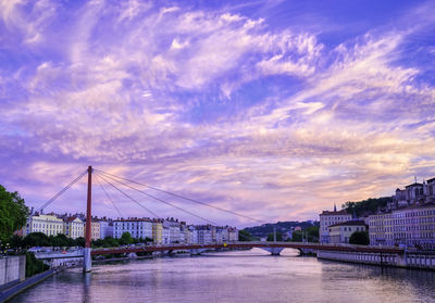 View of bridge over river against cloudy sky