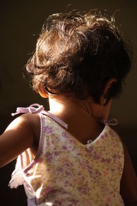 Rear view of girl looking at camera