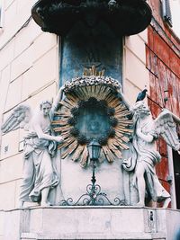 Low angle view of statue against building
