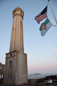 Low angle view of flags against clear sky