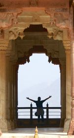 Statue of woman in front of a building